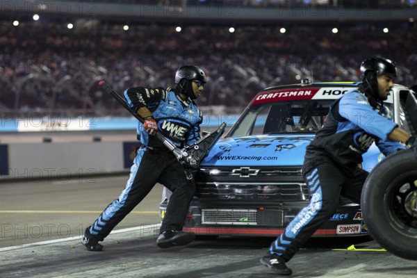 The crew of Niece Motorsports work on the car prior to performs a pit stop on pit road during the Craftsman 150 at the Phoenix Raceway in Avondale AZ