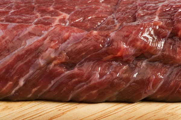 Raw beef steak meat on kitchen board close up