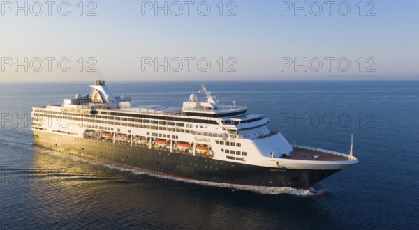 219 metre long cruise ship VEENDAM of the shipping company Holland-America-Line for 1350 passengers, Rotterdam class, built by the shipyard Fincantieri and put into service in 1995, owner: Carnival Corporation & plc, shortly after sunrise on the way past Cap Martin to the Principality of Monaco, French Riviera, Mediterranean Sea