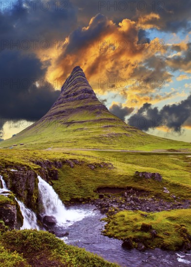 The famous mountain in Iceland is Kirkufell. At the foot of the mountain cascading waterfalls Kirkjoufellfoss. Magic sunset. The concept of exotic and extreme tourism