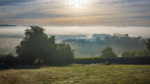 Early morning sunrise landscape with fog and mist in the rural part of Galicia, Spain, Europe