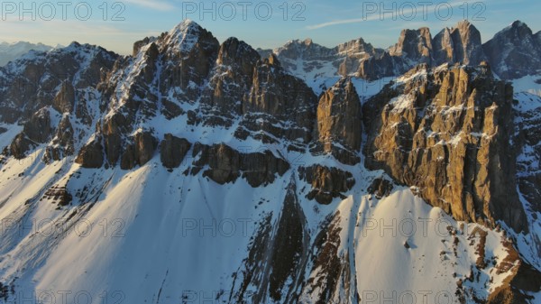 Aerial view of amazing rocky mountains in snow at sunrise, Dolomites, Italy, Europe