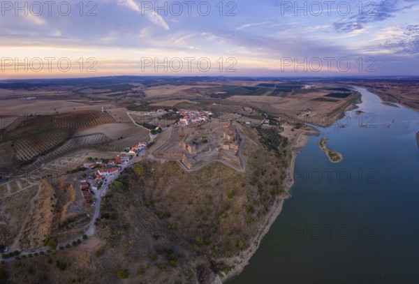 Juromenha castle, village and Guadiana river drone aerial view at sunset in Alentejo, Portugal, Europe