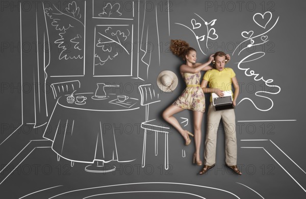 Love story concept of a romantic couple against chalk drawings background. Male listening to music in headphones and surfing the internet via laptop, female trying to attract his attention