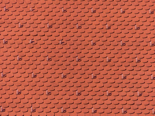 The roof of an old building (church) has been freshly renovated. New roof tiles on Haus Austria