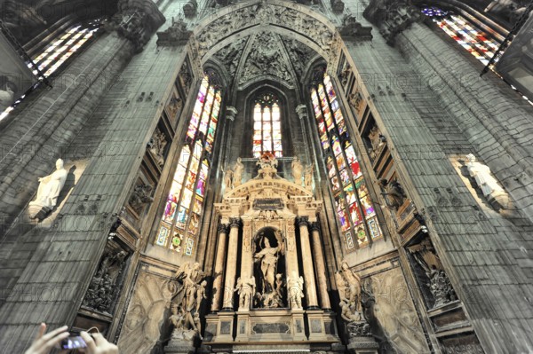 Milan Cathedral, Duomo, construction started in 1386, completed in 1858, Milan, Milano, Lombardy, Italy, Europe, Magnificent Gothic cathedral with an impressive altar flanked by stained glass windows and sacred statues, Europe