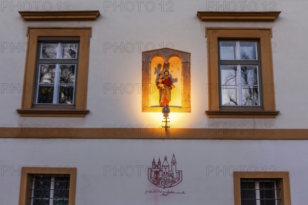 Sculptural group in a niche, saint holding the infant Jesus, depiction of the dissolution decree of Göß Abbey, former convent of the Benedictine nuns, Leoben, Styria, Austria, Europe