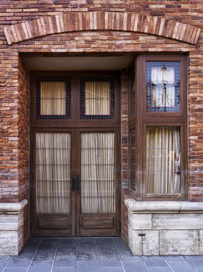 Vintage wooden door of old brick Venetian house