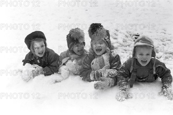 Winter in the 1950s. Children are playing in a park in Stockholm. They don't seem to be freezing. Sweden 1954. Ref 2A-14