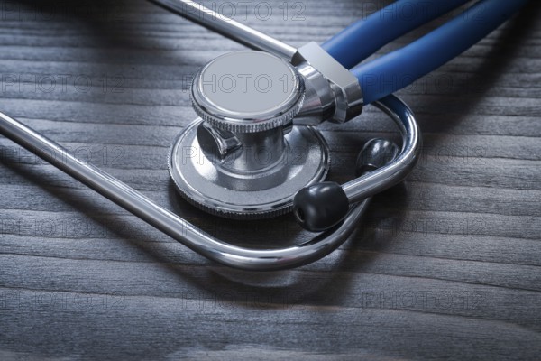 Wooden board with diagnostic medical stethoscope close up image medicine concept