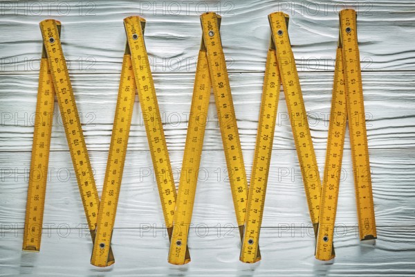 Yellow wooden meter on white board