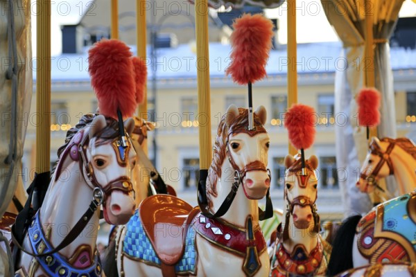 Colouful carousel horses on a traditional merry-go-round on Helsinki Christmas Market, Helsinki, Finland. December 10, 2019