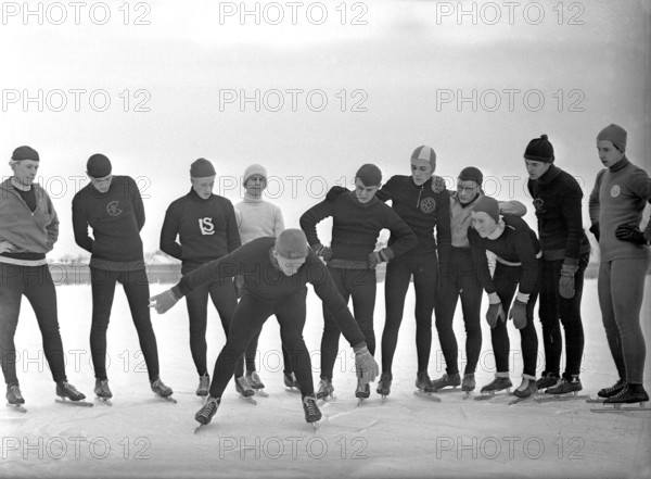 1930s winter activities. A group of amateur long distance scaters has gathered around a man who instructs them one or two things to think about when skating on the special skates. Sweden December 1939 Kristoffersson ref 52-3