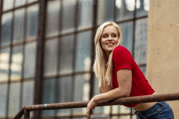 A beautiful blonde woman poses joyfully for the camera, showcasing her stylish spring clothing. With a bright smile and playful demeanor, she radiates happiness, embracing the upcoming gorgeous weather, Charlotte, United States of America