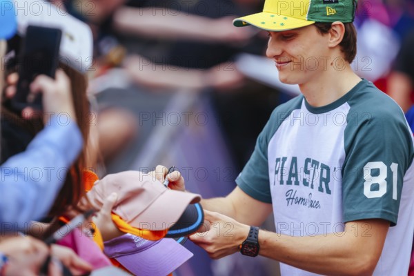 MELBOURNE, AUSTRALIA - MARCH 13: Oscar Piastri of Australia and McLaren Formula 1 Team with fans before the 2025 Australian Grand Prix at Albert Park in Melbourne, Australia, Oceania
