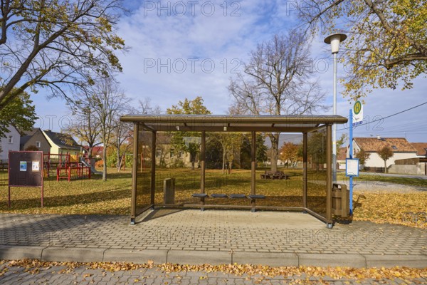 Möglenz bus stop with bus shelter, lantern and autumnal trees, Dorfstraße, Möglenz district, Bad Liebenwerda, Elbe-Elster district, Brandenburg, Germany, Europe