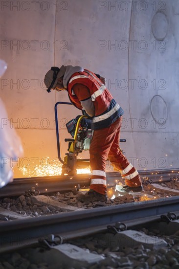 A worker grinding rails in a tunnel, sparks spraying, rail welding, track construction Hermann Hessebahn, Calw, Black Forest, Germany, Europe
