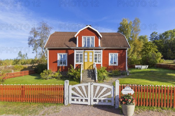 Katthult, red wooden farm house with fence from Astrid Lindgren's tales about Emil of Lönneberga at Gibberyd near Rumskulla, Vimmerby, Småland, Sweden, Europe