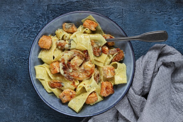Papardelle pasta in creamy sauce with seafood, homemade, no people