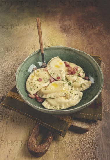 Dumplings, with fried prosciutto, a traditional dish of Polish cuisine, dumplings, top view, close-up, without people
