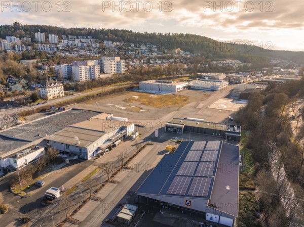 View of industrial area with solar panels and surrounding hills, Nagold, Black Forest, Germany, Europe