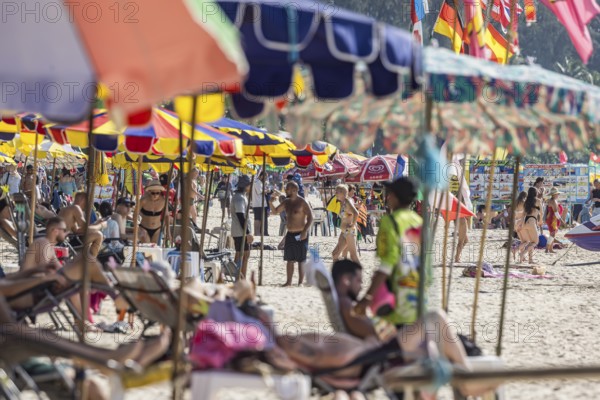 Overtourism in Thailand. Mass tourism on the sandy beach of Patong, the deckchairs are packed closely together. The beach stretches for around three kilometres along the Indian Ocean. Patong, Kathu, Phuket Island, Thailand, Asia