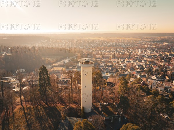 Panoramic view of a town with a central tower surrounded by autumnal colours, Böblingen, Germany, Europe
