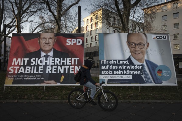 Election posters of the candidates for chancellor Olaf Scholz (SPD, left) and Friedrich Merz (CDU, right) stand on the roadside in Frankfurt am Main. On 23 February 2025, early federal elections will be held in Germany, Frankfurt am Main, Osthafen, Hesse, Germany, Europe