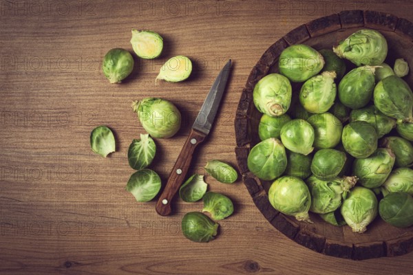 Fresh Brussels sprouts, raw, top view, on a wooden table, no people