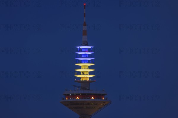 The Europe Tower in Frankfurt am Main shines in the Ukrainian national colours yellow and blue on the evening of 24.02.2024. Exactly two years ago, on 24 February 2022, Russia launched a war of aggression against Ukraine, Frankfurt am Main, Hesse, Germany, Europe