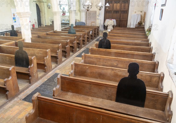 First World War remembrance figures of soldiers sitting in church pews, Framsden, Suffolk, England, UK