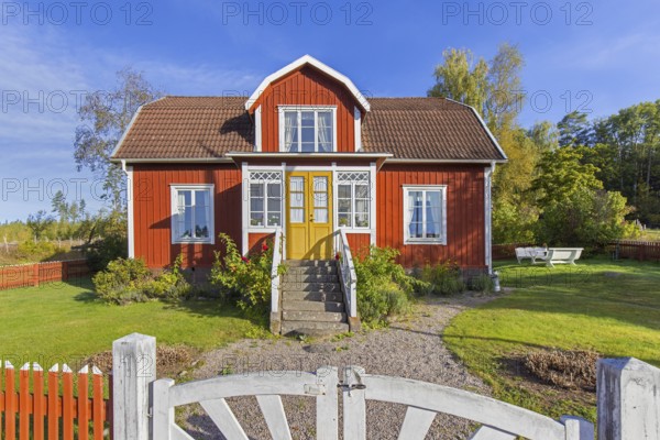 Katthult, red wooden farm house with fence from Astrid Lindgren's tales about Emil of Lönneberga at Gibberyd near Rumskulla, Vimmerby, Småland, Sweden, Europe