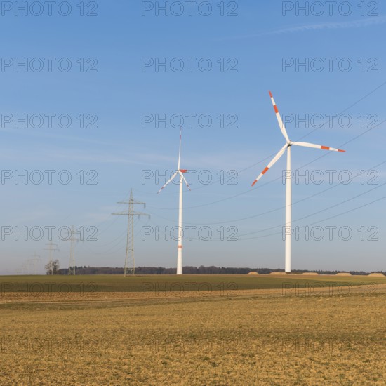 Wind turbines and power lines in an autumnal field under a clear sky, solar park, near Ulm, Swabian Alb, Baden-Württemberg, Germany, Europe