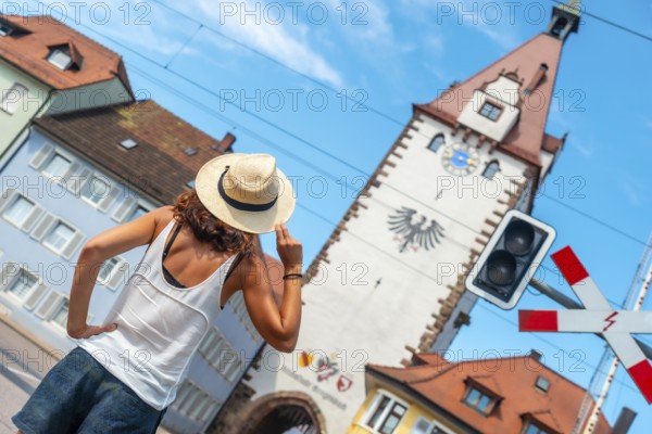 A female tourist at the Kinzigtor tower in the village of Gengenbach in the Black Forest, Germany, Europe