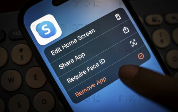In this photo illustration, a person holds a mobile phone displaying Skype application, in Guwahati, India on 3 March 2025. Skype is shutting down in May 2025, and Microsoft is moving users to Teams