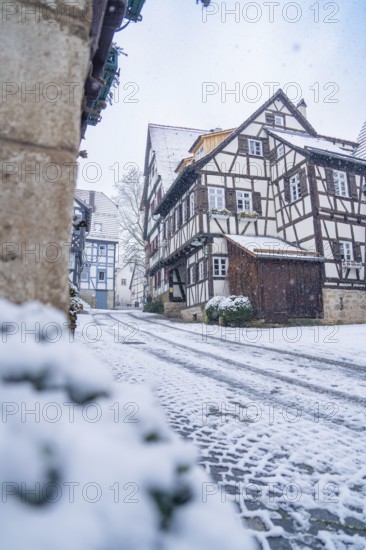 Snow-covered village street with traditional half-timbered houses in a quiet winter atmosphere, Sindelfingen, Germany, Europe