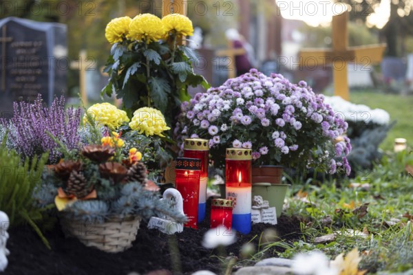 All Saints' Day at the Bergfriedhof cemetery in Stuttgart. Catholics commemorate their deceased relatives. Grave decorations and candles. Stuttgart, Baden-Württemberg, Germany, Europe