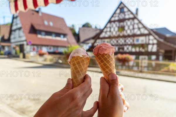 Eating ice cream in summer in the medieval mountain village of Sasbachwalden, Black Forest, Germany, Europe