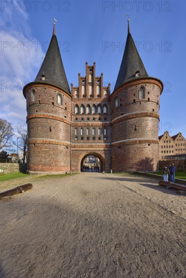City gate, historic brick building, footpath made of sand, Holstentorplatz, Hanseatic city of Lübeck, independent city, Schleswig-Holstein, Germany, Europe