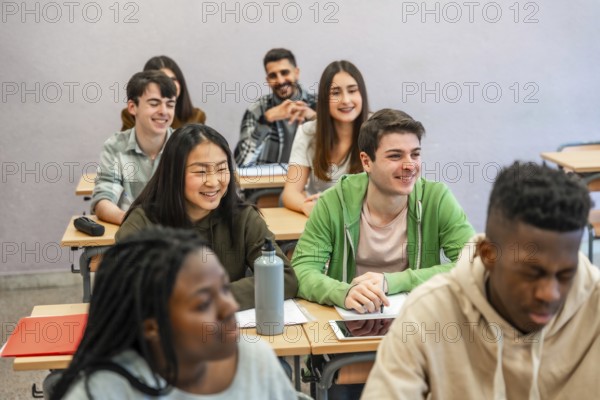 Multi ethnic university students attending a lesson and smiling, concept of education and integration