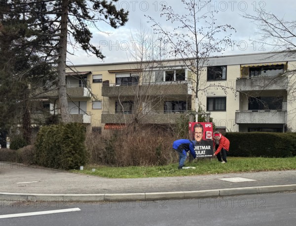 A scene in a residential area with trees, pavement and people working on an election poster, election advertising, Bundestag election 2025, SPD, Sven Bullat, Stuttgart, Baden-Würrtemberg, Germany, Europe