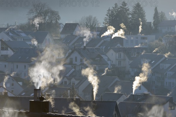 Smoke rising from the chimneys of a housing estate at dawn, Korb im Remstal, Baden-Württemberg, Germany, Europe