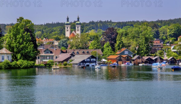 Waterfront with boathouses and towers of the parish church, Tutzing, Lake Starnberg, Bavarian Alpine Foreland, Upper Bavaria, Bavaria, Germany, Europe