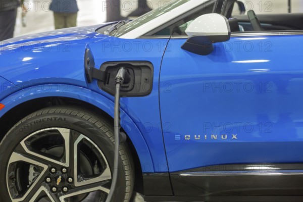 Detroit, Michigan USA - 10 January 2025 - The Chevrolet Equinox EV, plugged into a charging station at the 2025 Detroit Auto Show