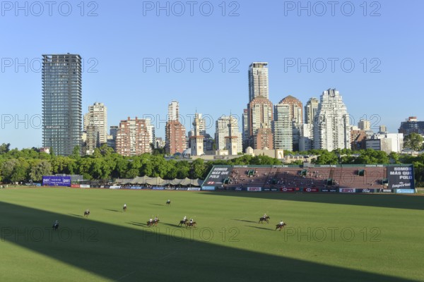 Scene from the 131st Argentine Open Polo Championship (Spanish: Campeonato Argentino Abierto de Polo), the most important international polo tournament, match Cria la Dolfina (blue) against La Ensenada (black), on 2 November 2024, with the skyline of Palermo, Buenos Aires, Argentina, South America