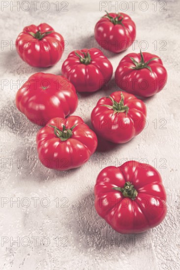 Pink tomatoes scattered on the table, top view, close-up, no people