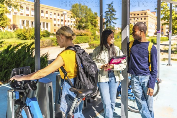 Student choosing bike in a public bicycle service area next to multi-ethnic friends