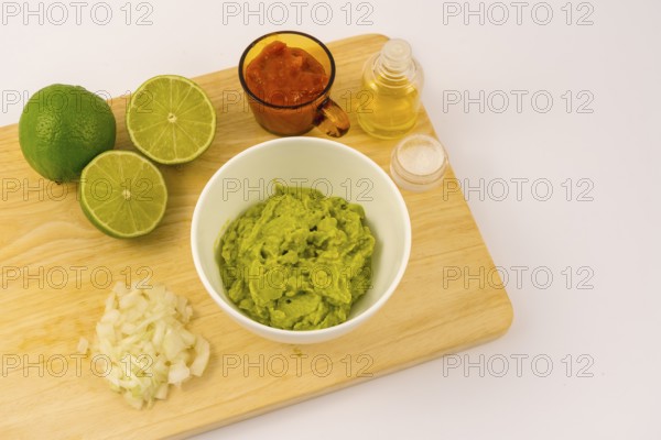 Crushed avocado in a white bowl. Recipe to prepare a nice guacamole
