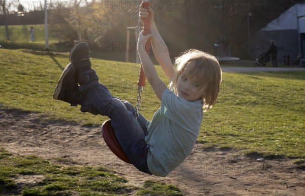 Little boy, 5 years, blond, playground, rides with cable car, backlight, playground, Stuttgart, Baden-Württemberg, Germany, Europe