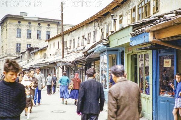 People walking along street of small shops, Sarajevo, Bosnia and Herzegovina, former Yugoslavia, Europe 1960, Europe